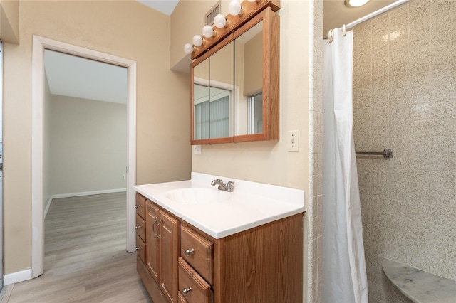 bathroom with vanity, hardwood / wood-style flooring, and walk in shower