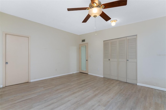 unfurnished bedroom with a closet, light wood-type flooring, and ceiling fan