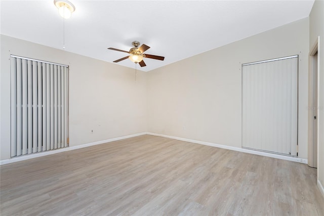 spare room featuring light hardwood / wood-style flooring and ceiling fan