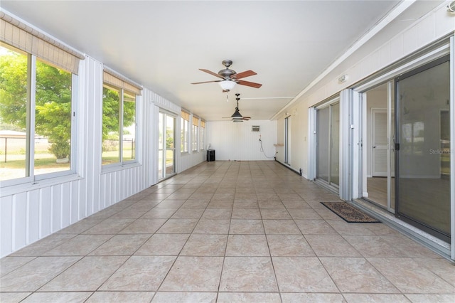 unfurnished sunroom with ceiling fan and a wealth of natural light