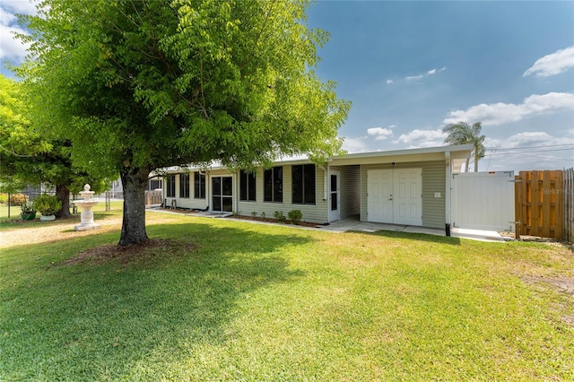 rear view of property featuring a yard