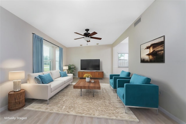 living room with a wealth of natural light, hardwood / wood-style floors, and ceiling fan