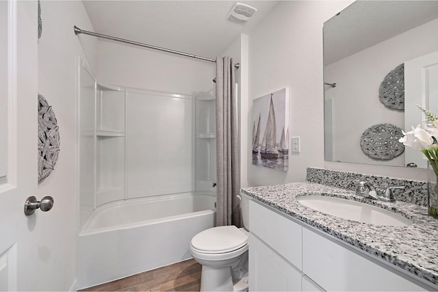 full bathroom with shower / bathing tub combination, wood-type flooring, vanity, and toilet