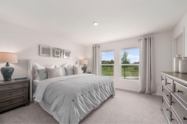 carpeted bedroom featuring a textured ceiling