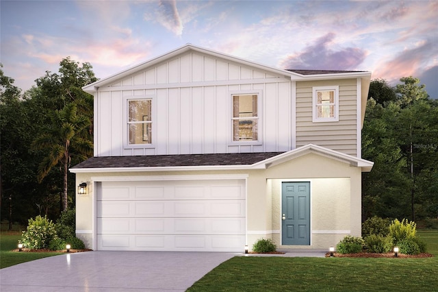 view of front of property with a garage and a lawn