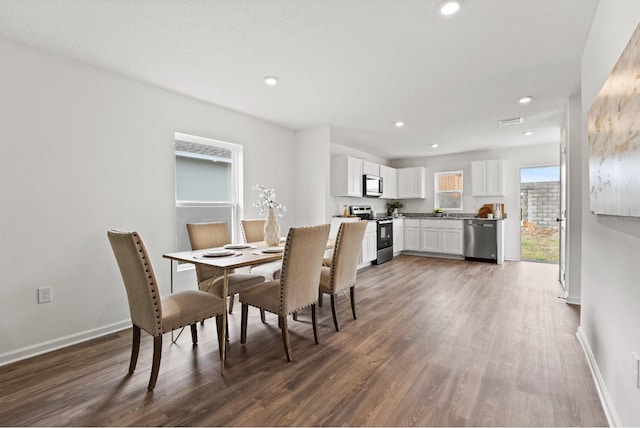 dining space featuring dark hardwood / wood-style floors and sink