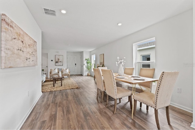 dining space with dark hardwood / wood-style floors