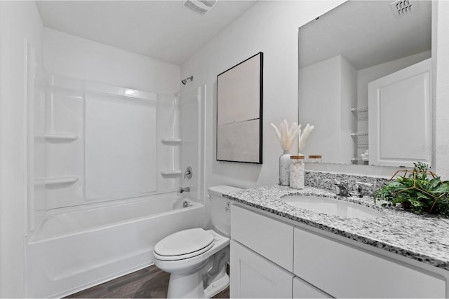 full bathroom featuring vanity, hardwood / wood-style floors, toilet, and washtub / shower combination