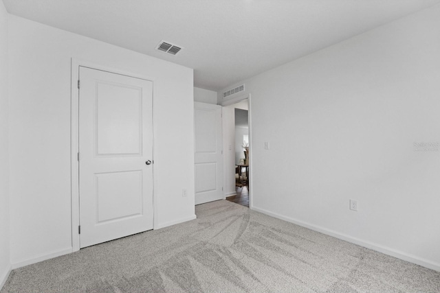 unfurnished bedroom with light carpet