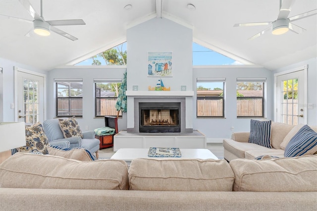 living room with ceiling fan, high vaulted ceiling, and plenty of natural light