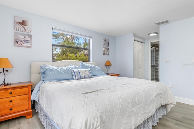 bedroom featuring light hardwood / wood-style flooring and a closet