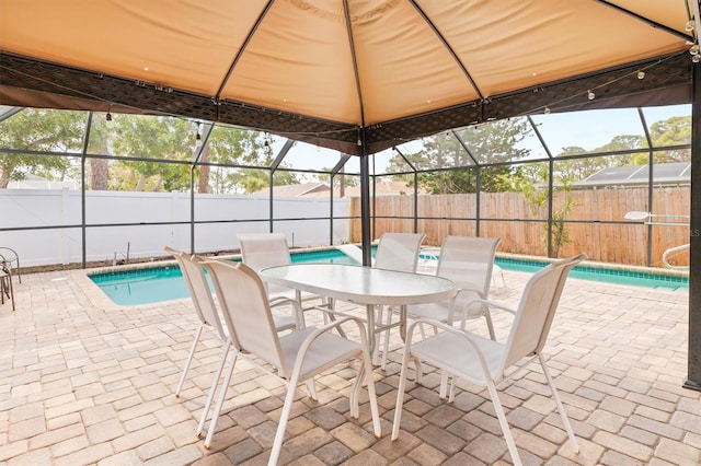 view of pool featuring a patio and glass enclosure