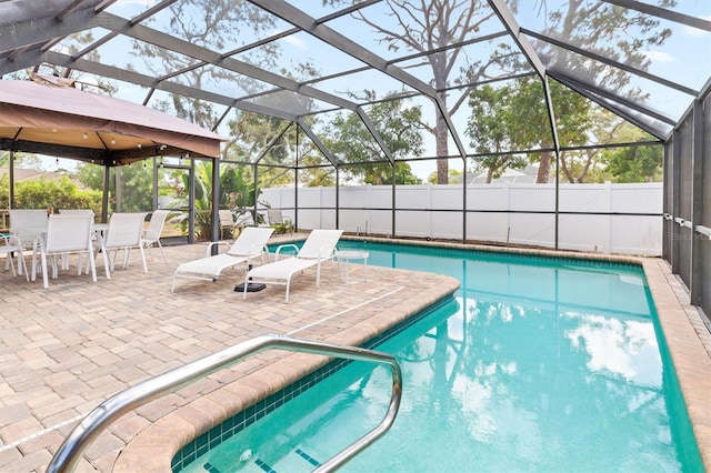 view of pool featuring a patio area and glass enclosure