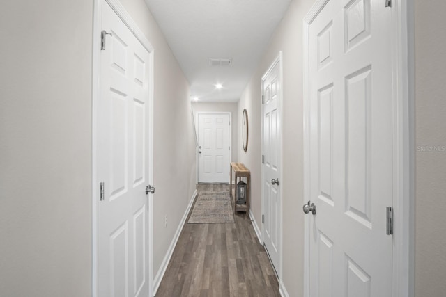 corridor featuring dark wood-type flooring