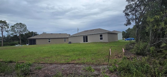 back of house with a lawn