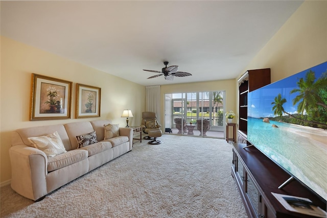 carpeted living room with ceiling fan