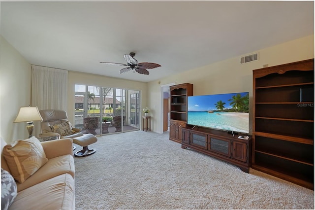 living room with ceiling fan and carpet flooring