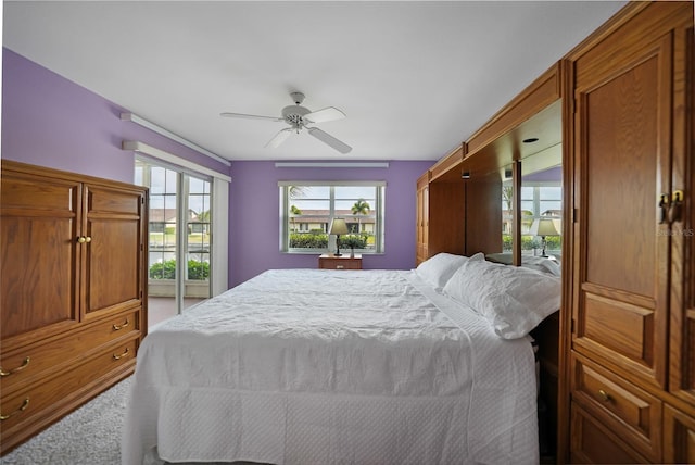 carpeted bedroom with multiple windows and ceiling fan