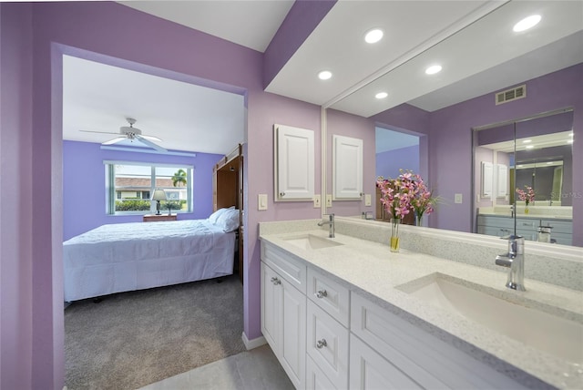 bathroom featuring tile floors, ceiling fan, and double sink vanity