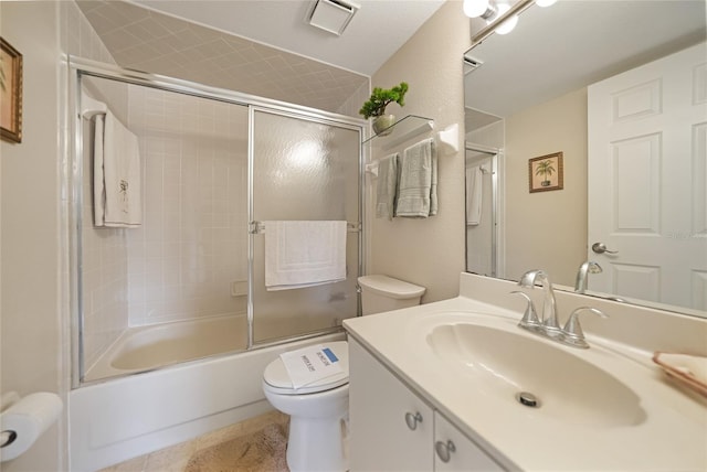 full bathroom with tile floors, combined bath / shower with glass door, vanity, and toilet