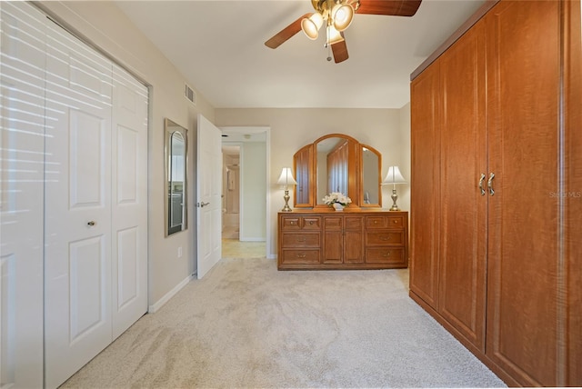 carpeted bedroom featuring a closet and ceiling fan