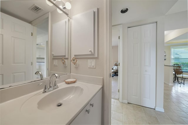 bathroom featuring tile flooring and vanity