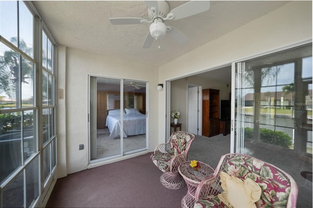 sunroom featuring ceiling fan and a wealth of natural light