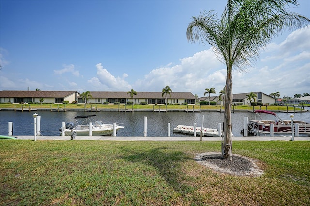 dock area with a water view and a lawn