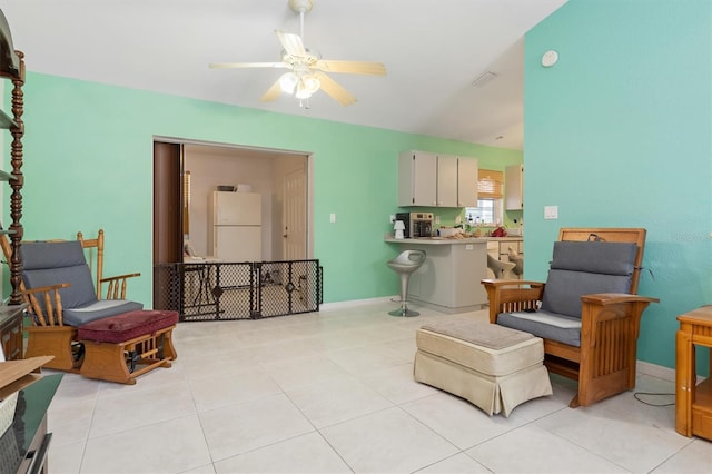 sitting room featuring ceiling fan and light tile floors