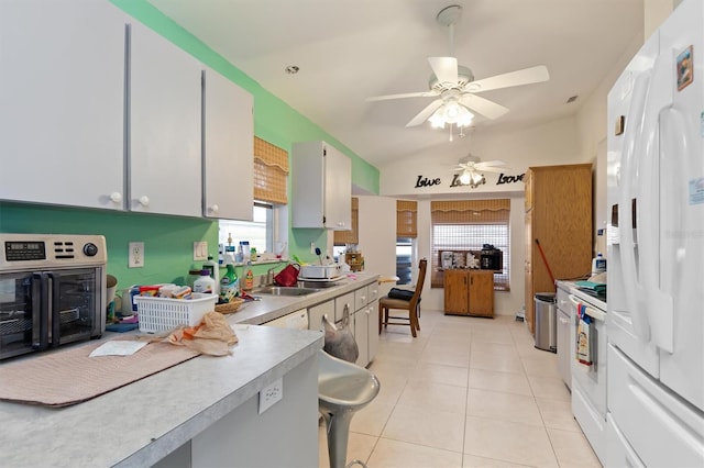 kitchen featuring ceiling fan, light tile floors, white cabinets, white appliances, and lofted ceiling