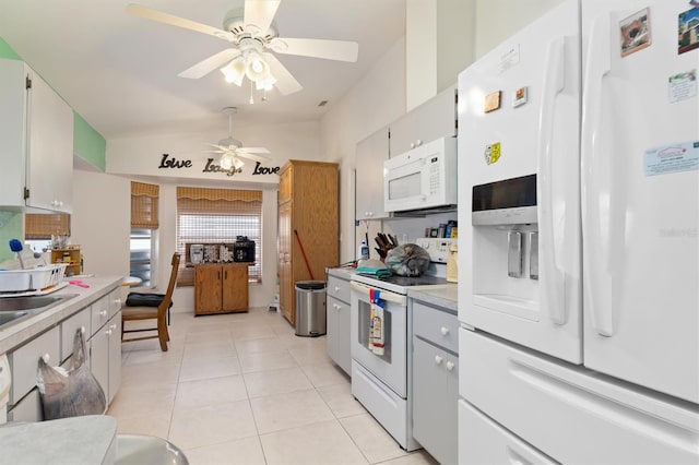 kitchen featuring gray cabinets, white appliances, ceiling fan, light tile flooring, and lofted ceiling