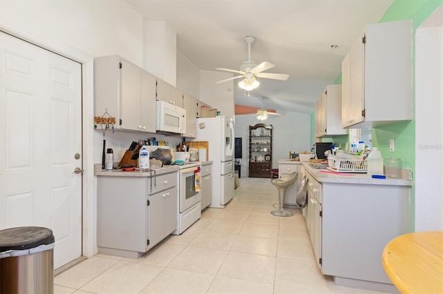 kitchen featuring white cabinets, white appliances, light tile flooring, and ceiling fan