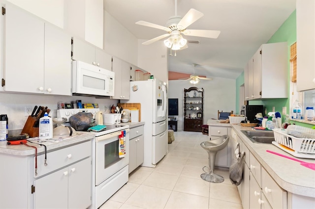 kitchen with high vaulted ceiling, white appliances, light tile flooring, and ceiling fan