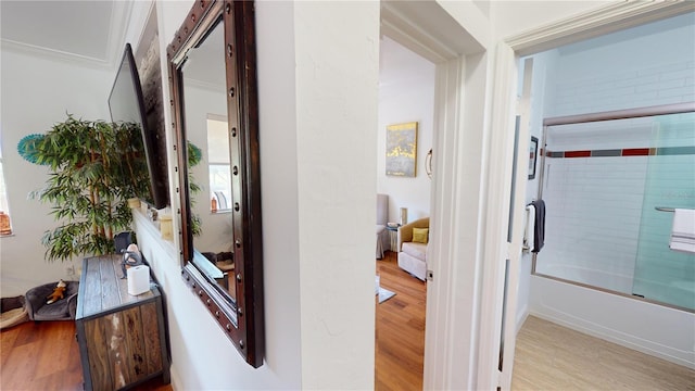 hall with crown molding and hardwood / wood-style flooring