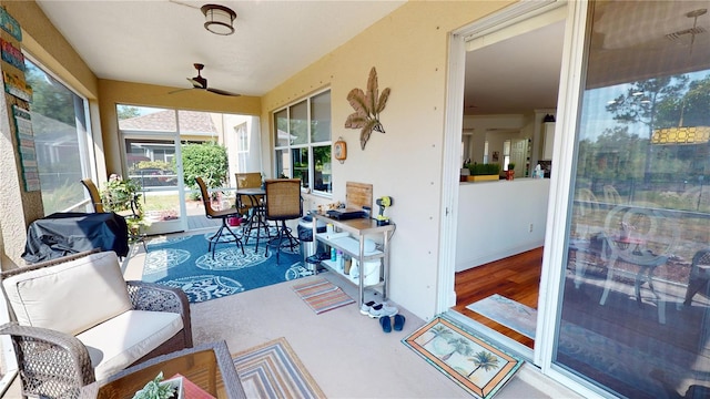 sunroom / solarium featuring ceiling fan