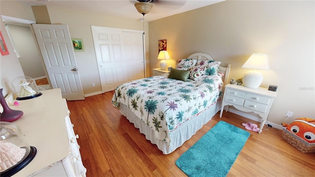 bedroom with a closet, ceiling fan, and light hardwood / wood-style flooring