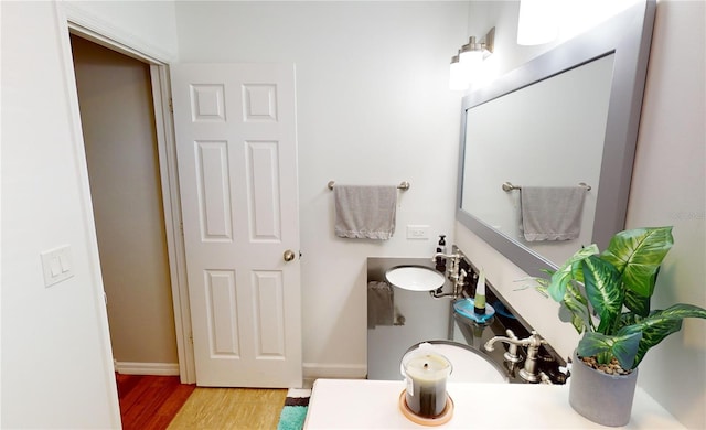 bathroom with sink and hardwood / wood-style flooring