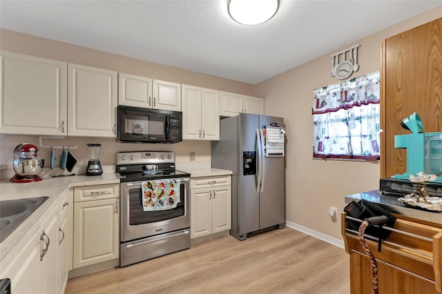 kitchen featuring light hardwood / wood-style flooring, stainless steel appliances, and white cabinetry