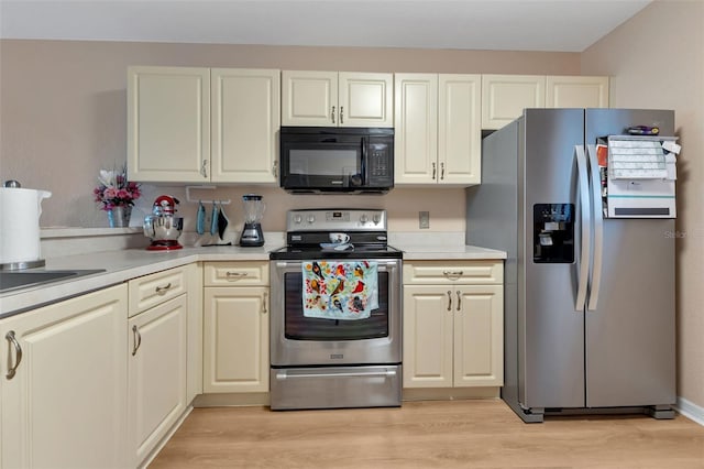 kitchen with light wood-type flooring and stainless steel appliances