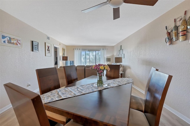 dining room with ceiling fan and hardwood / wood-style floors