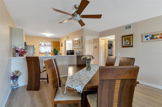 dining room featuring light hardwood / wood-style flooring and ceiling fan