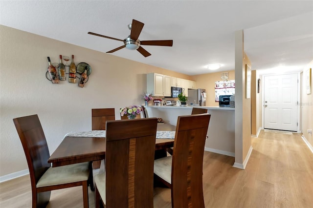 dining room featuring light hardwood / wood-style floors and ceiling fan