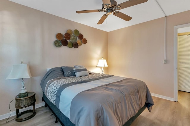 bedroom with light hardwood / wood-style flooring and ceiling fan