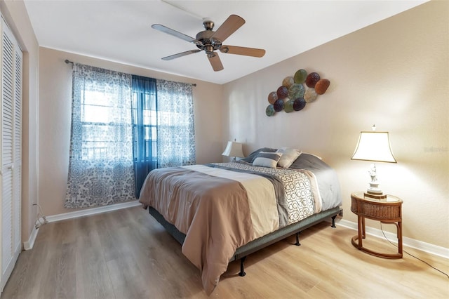 bedroom featuring wood-type flooring, ceiling fan, and a closet