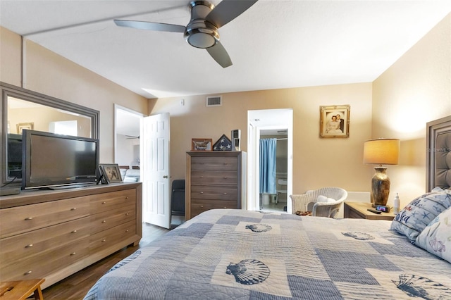 bedroom featuring connected bathroom, ceiling fan, and dark wood-type flooring