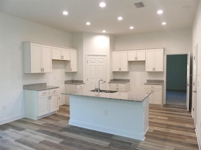 kitchen featuring white cabinetry and sink