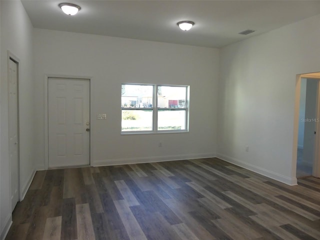 empty room with dark wood-type flooring