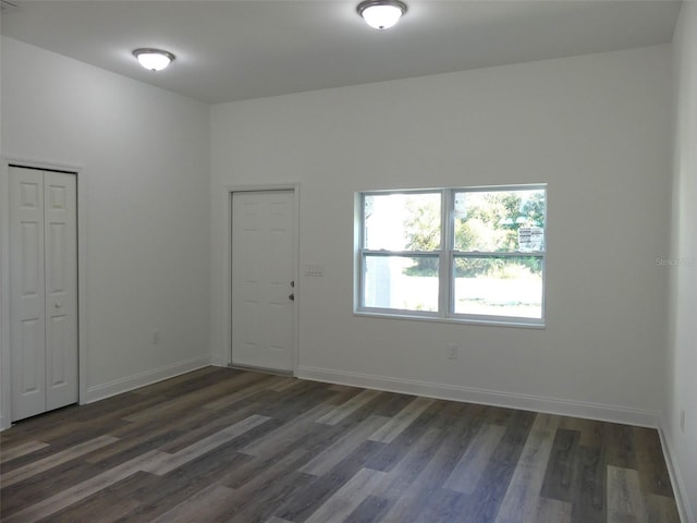 unfurnished room featuring dark hardwood / wood-style floors