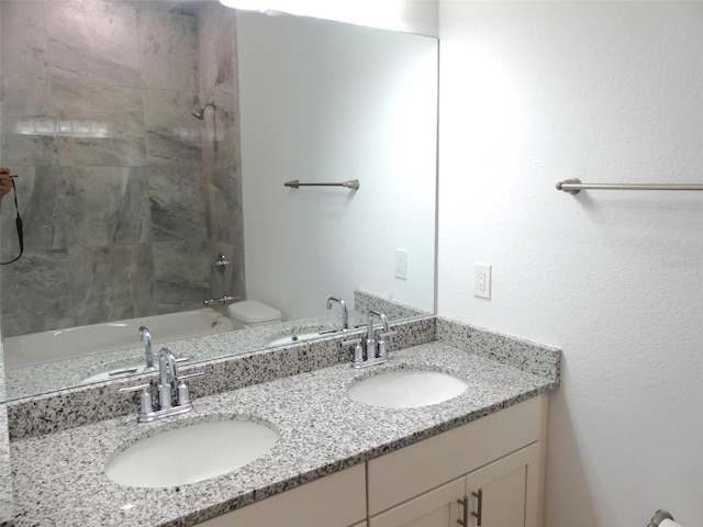 full bathroom with vanity, toilet, and tiled shower / bath combo