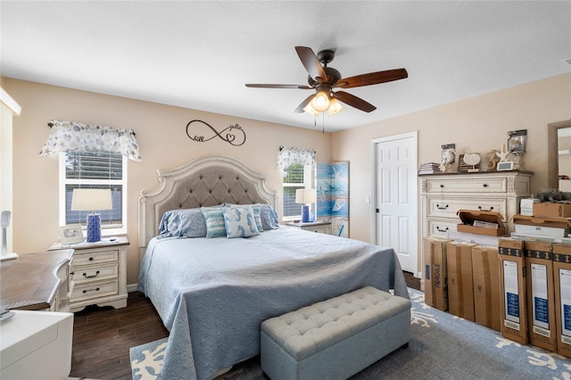 bedroom with dark hardwood / wood-style flooring and ceiling fan